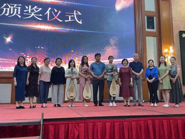 颁奖仪式上各专业组第一名的三位选手获得了由周强琵琶工作室赞助的价值万元红酸枝琵琶